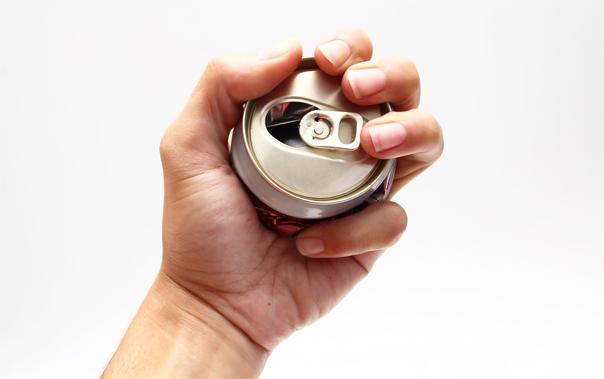 Hand crushing a soda can